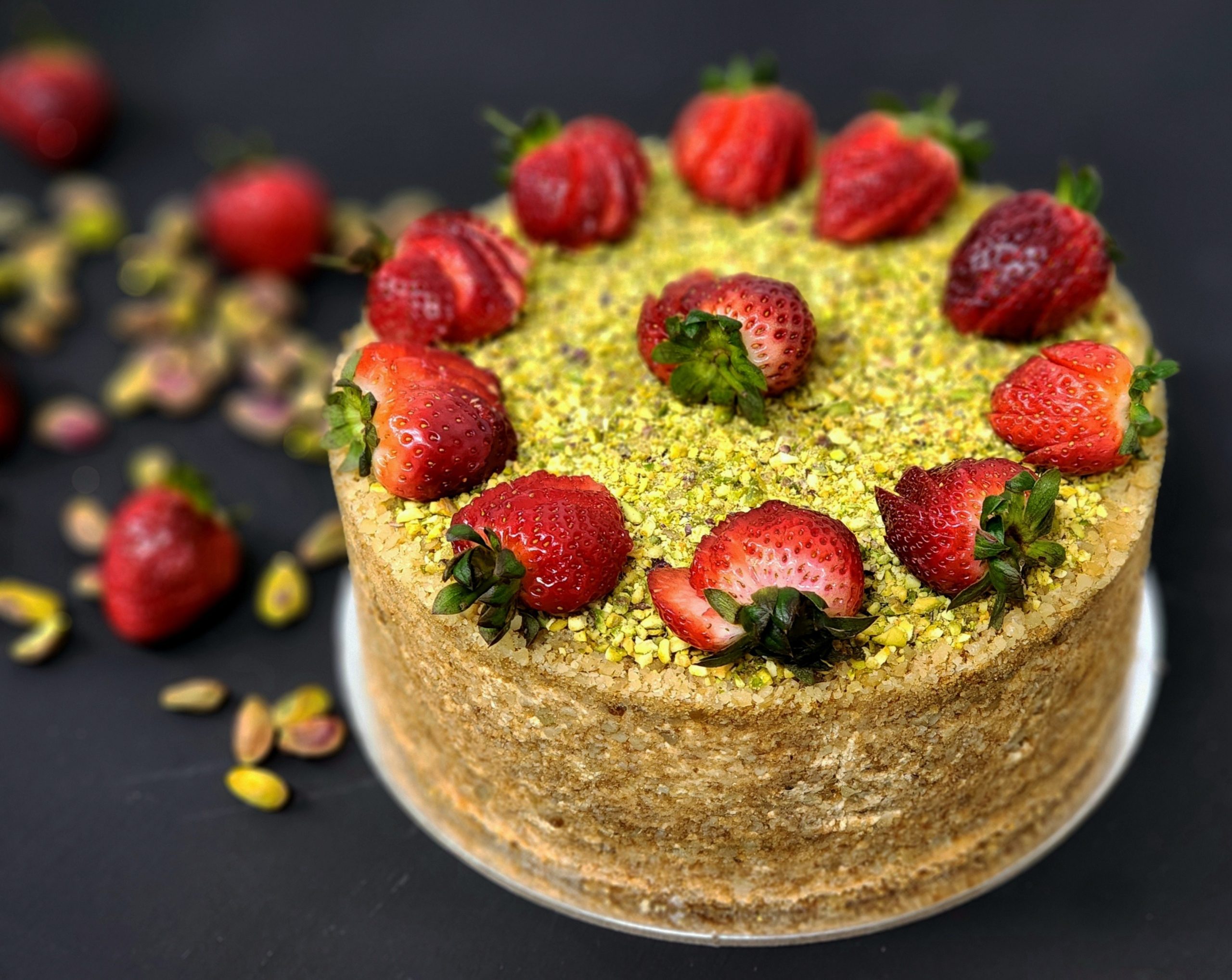 Honey cake with pistachios, strawberries